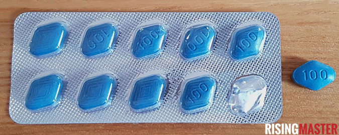 photo of a blister pack of sildamax pills and one blue pill on a table